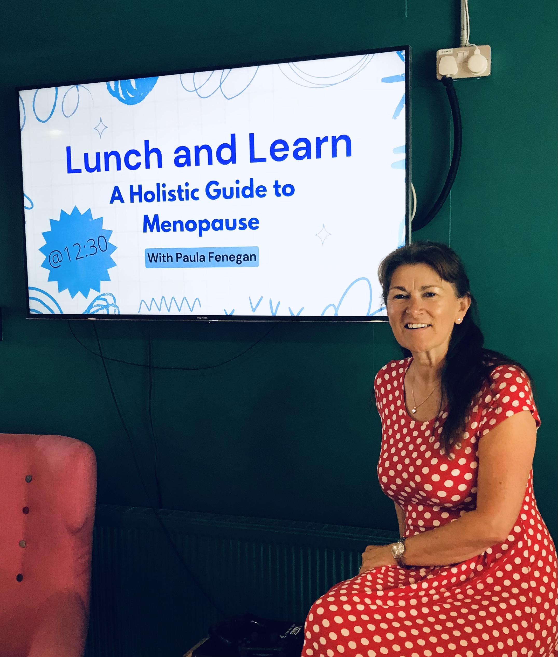 Paula Fenegan Wellbeing speaker in red and white poka dot dress at Lunch and Learn event